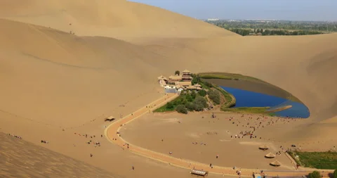 Time lapse of Dunhuang Crescent Spring and Singing Sand Mountain Stock Footage 295737574