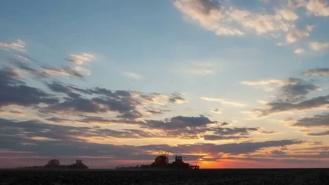 Time lapse of dusk with sunset and flowing colorful clouds above the field Stock Footage 75332400