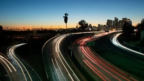 Time lapse of dusk traffic streaks on the I-10 and 101 Freeway merge in L.A. Stock Footage 101760616