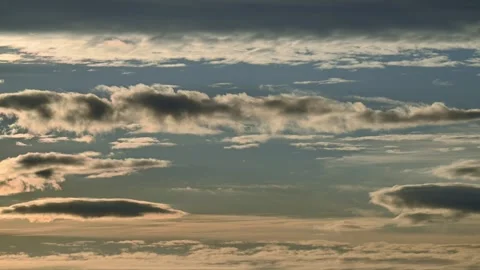 Time lapse early evening light blue sky with layers of clouds moving at speeds Stock Footage 288011885