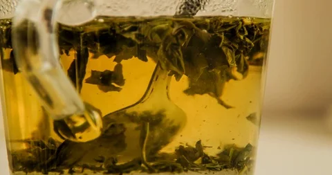 Time-lapse of eating, drink, hot fruit tea in a glass teapot Stock-Footage 129595635