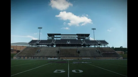 Time-lapse of Eclipse at J Fred Johnson Stadium while students look Stock Footage 79540900