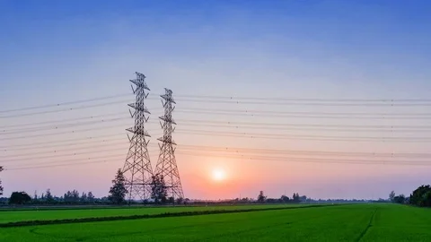 Time lapse Electric pole, High voltage towers and sky sunset and green rice Stock-Footage 72805789