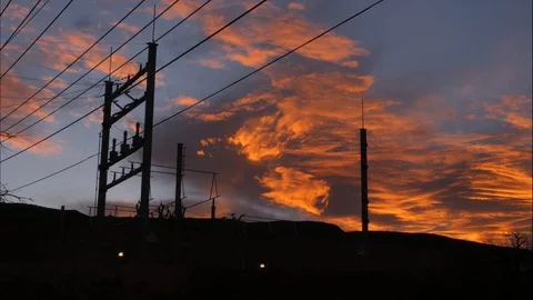 Time Lapse Electrical lines with a red sky sunrise.  Stock Footage 94580863