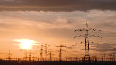 TIME LAPSE: Electrical towers in front of a red sky and clouds Stock Footage