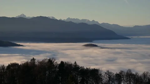 Time lapse elevated view above inversion clouds rolling in Alpine valley Stock Footage 143826912