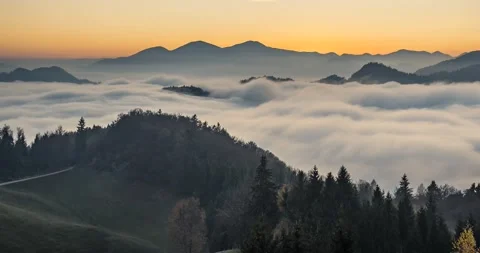 Time lapse elevated view of low inversion clouds moving in the valley at sunset Stock Footage 143158436