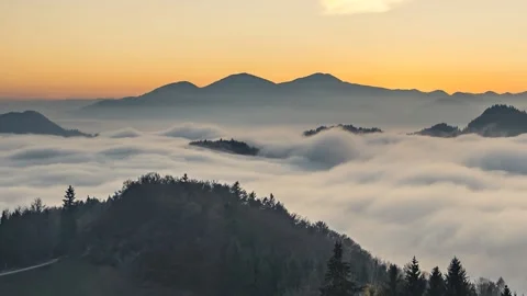 Time lapse elevated view of low inversion clouds moving in valley Stock Footage 143158443
