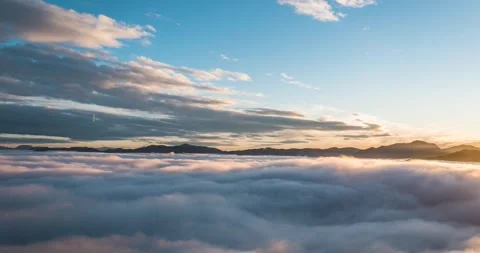 Time lapse: Elevated view of low fog moving across the valley Stock Footage 260296072