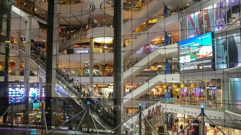 Time lapse of an escalator and people passing in a big round square at a mall. Stock Footage 122665731