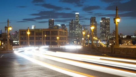 Time lapse of evening clouds and car lights in front of the Los Angeles skyline Stock Footage 125458498