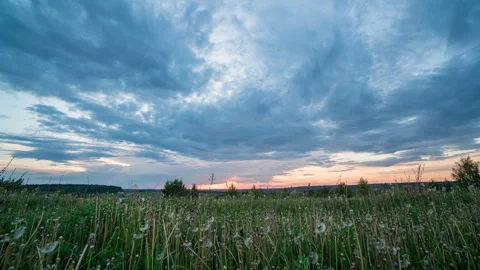 Time lapse of an evening sunset in a field with camera movement, hyperlapse of a Stock Footage 277180148