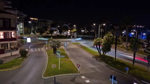Time-lapse of evening traffic at a roundabout in Antibes with the city lights Stock-Footage 337774034