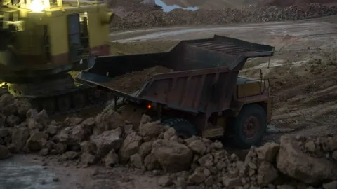 Time lapse of excavator loading ore into dump-trucks at the sunset. Stock Footage 91586664