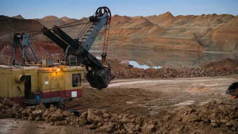 Time lapse of excavator loading ore into dump-trucks at the sunset. Stock Footage 91587014