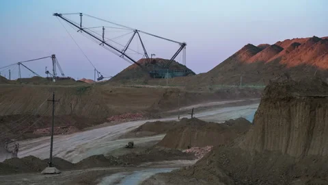 Time lapse. Excavators load ore into dump-trucks. This area has been mined for Video stock 88800521