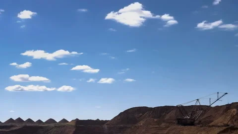 Time lapse. Excavators load ore into dump-trucks. This area has been mined for Stock Footage 88800701
