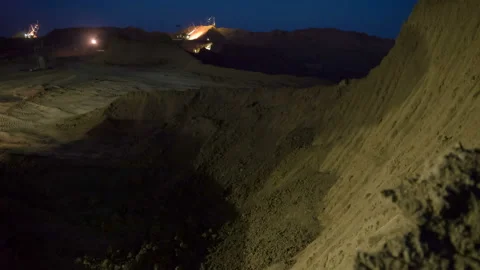 Time lapse. Excavators load ore into dump-trucks. This area has been mined for Stock Footage 91584706