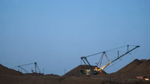 Time lapse of excavators loading ore into dump-trucks at the sunset. Stock Footage 91585385