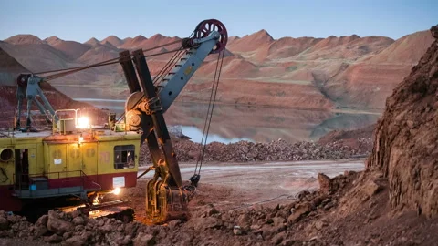 Time lapse of excavators loading ore into dump-trucks at the sunset. Stock Footage 91585726