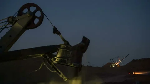 Time lapse of excavators loading ore into dump-trucks at the sunset. Stock Footage 91586021
