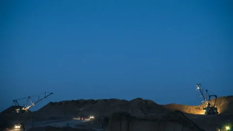 Time lapse of excavators loading ore into dump-trucks at the sunset. Stock Footage 91586307