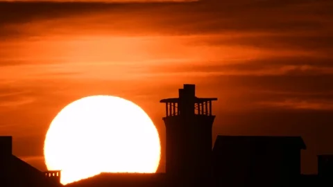 Time lapse - Extreme close up of the sun setting with dramatic clouds at sunset Stock Footage 94230586