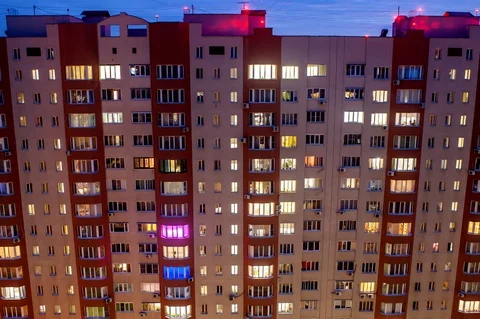 Time lapse of the facade of a residential multi-story building in the evening Stock Footage 129946563