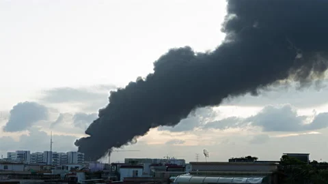 Time lapse of a factory catched a fire with lots dark smoke Stock Footage 205469405