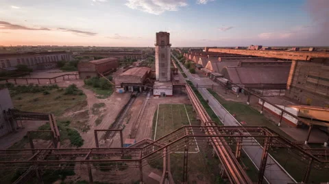 Time lapse. Factory at sunset. Tower. Blue sky. Moving clouds Stock Footage 63764012