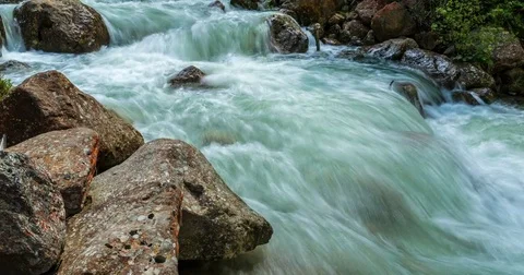 Time-lapse of fast flowing river in the snowy mountains of Austria. 4K Stock-Footage 73185775