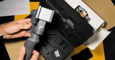 Time lapse fast motion of man hands unpacking and setting DJI Osmo Mobile 2 Video stock 100821132