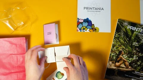 Time lapse fast motion overhead view of woman unboxing perfume Stock Footage 118661630