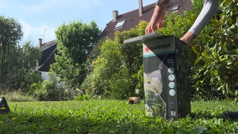 Time-Lapse: Fast Motion Unboxing Gardena Electric Pump in Garden Stock Footage 269500261
