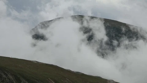 Time lapse of fast mouving clouds and cars on mountain road. Spectacular big Stock Footage 91446213