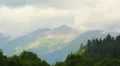 Time-lapse fast-moving clouds in the sky over mountains HD Footage
