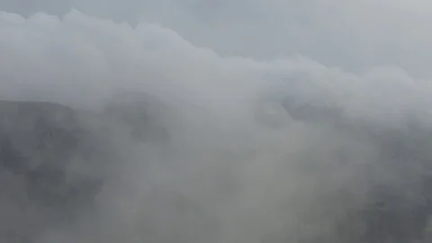 Time lapse of fast moving clouds up in the mountains. Heavy fog Stock Footage 91446209