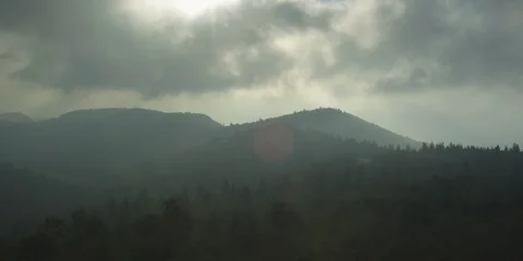 Time-lapse of fast-moving clouds moving over mountain ranges  Stock Footage 103785597