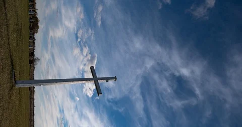 Time-lapse of fast moving clouds in a blue sky with a large white cross Stock Footage 108496603
