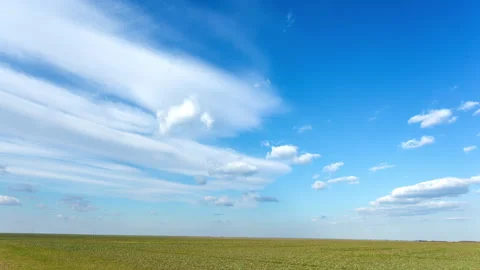 Time lapse of fast moving clouds in rape field Stock Footage 246762118