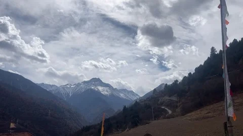 Time-lapse of Fast Moving Clouds Over Tibetan Highlands and Prayer Flags Video stock 329342877