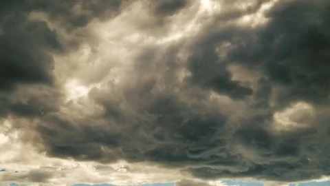 Time-lapse. Fast moving dark clouds before a thunder-storm. The sun breaks Stock Footage 79942061