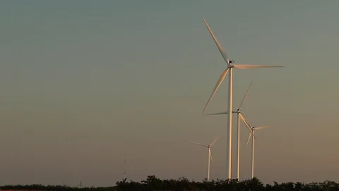 Time lapse fast spinning wind mills in the sunrise light Stock Footage 93368468