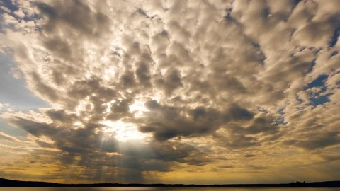 Time lapse. Fast. Sunrays shining from the blue and yellow sky through clouds Stock Footage 111155883