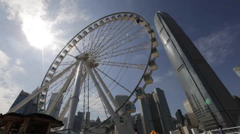 Time Lapse of the Ferris wheel turning near IFC building in Hong Kong Central Stock Footage 45379287