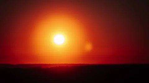 Time-Lapse: Fiery Sunset Over Silhouetted Forest Horizon Stock Footage 303855922