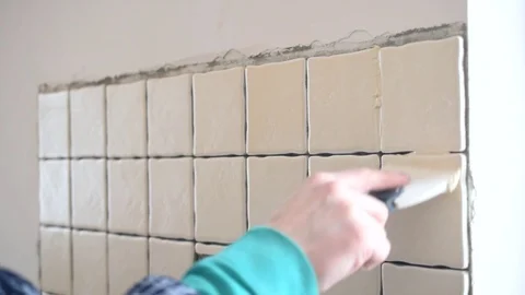 Time lapse of filling gaps between tiles with grout Stock Footage 74805692