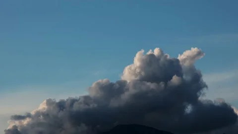Time-lapse filming of cloud formation over a mountain at sunset Stock Footage 235075944