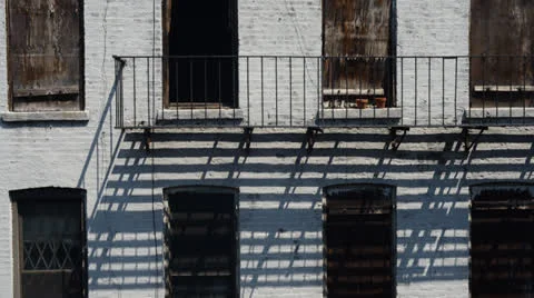 Time lapse of fire escape railing and its shadows in New York City Vídeo Stock 23374460