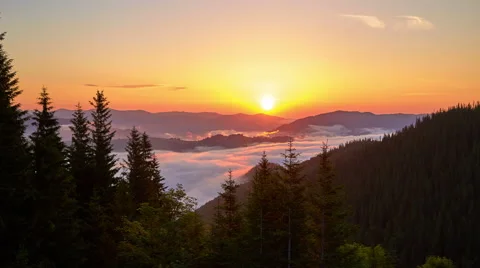 Time lapse of the floating clouds between mountains on the sunrise background Stock Footage 68144234